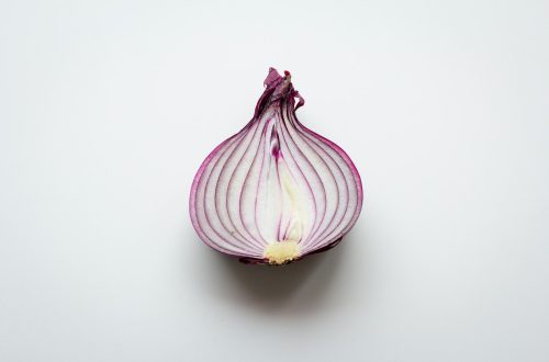 pink and white garlic on white surface